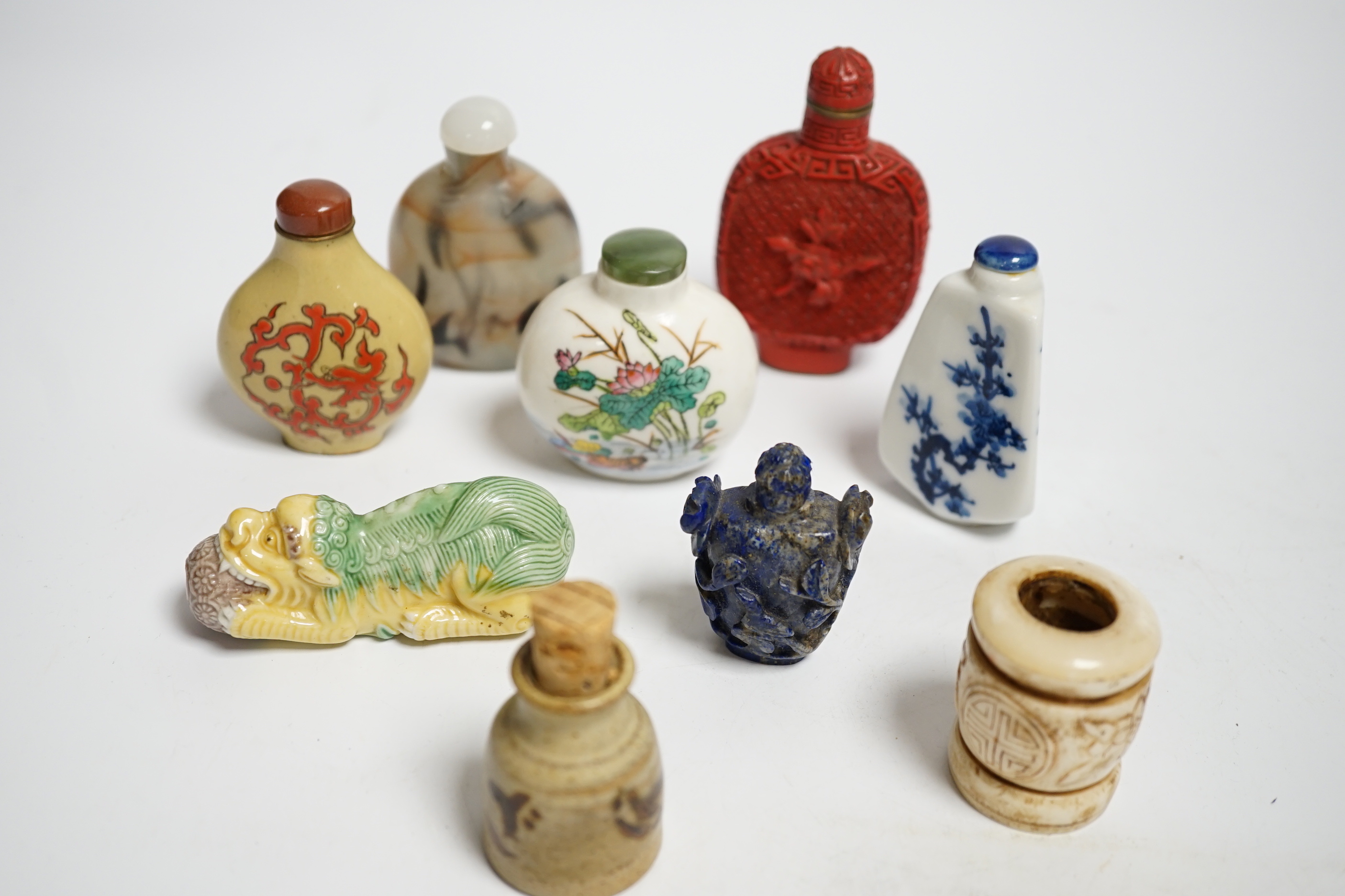 Seven various snuff bottles including simulated cinnabar lacquer, lapis lazuli, ceramic etc. together with a pottery vessel and another bone (9)
